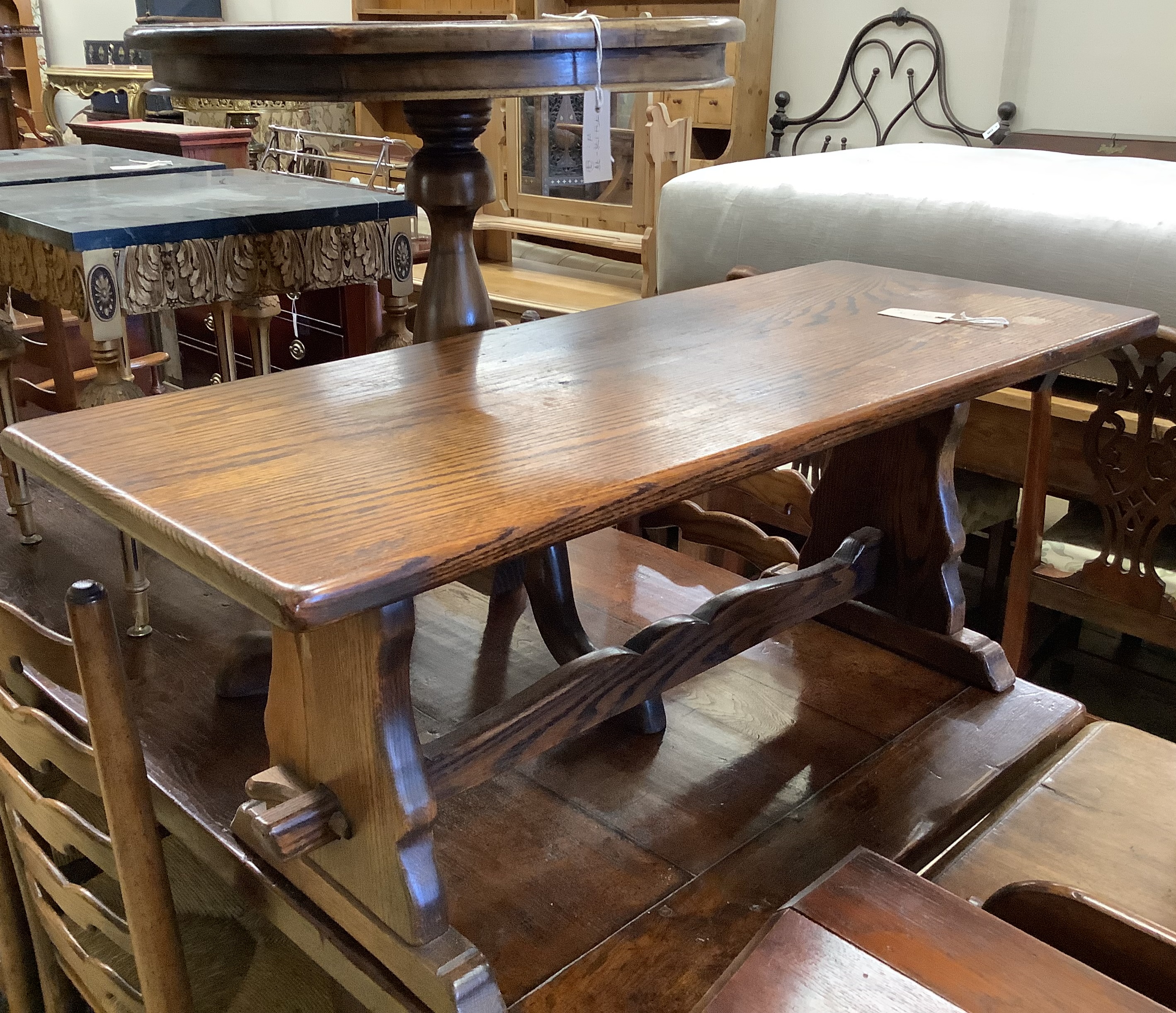 A circular mahogany occasional table on tripod base, diameter 60cm, height 70cm together with a rectangular oak low occasional table, width 106cm, height 42cm